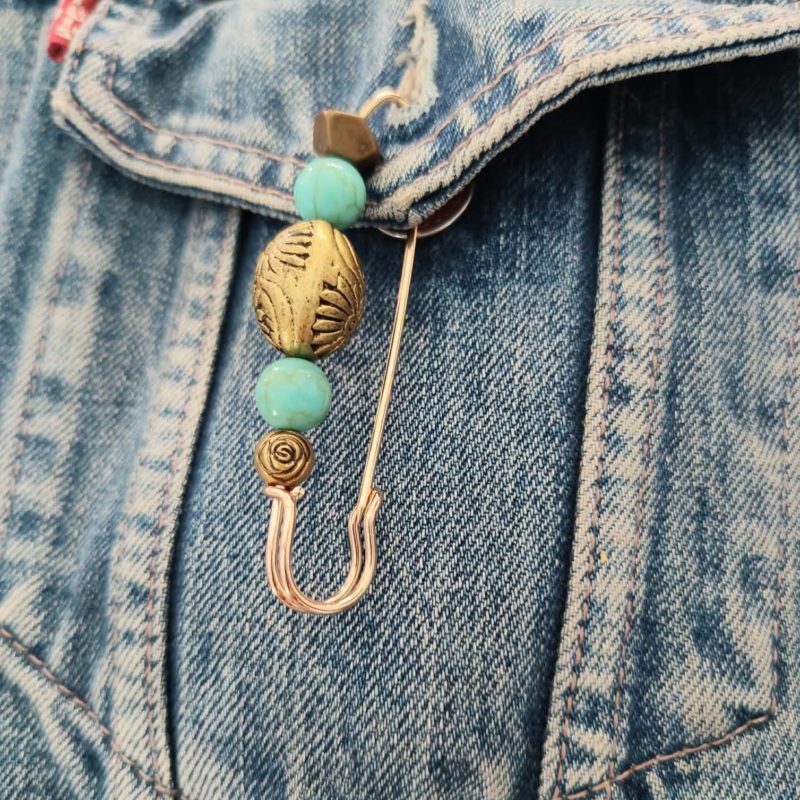 Biker safety pin attached to a denim vest